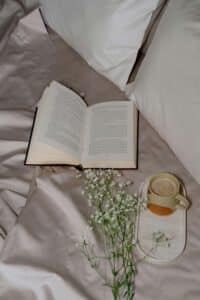 Cup of tea placed on white fabric, simple scene conveying warmth, rest, and quiet presence