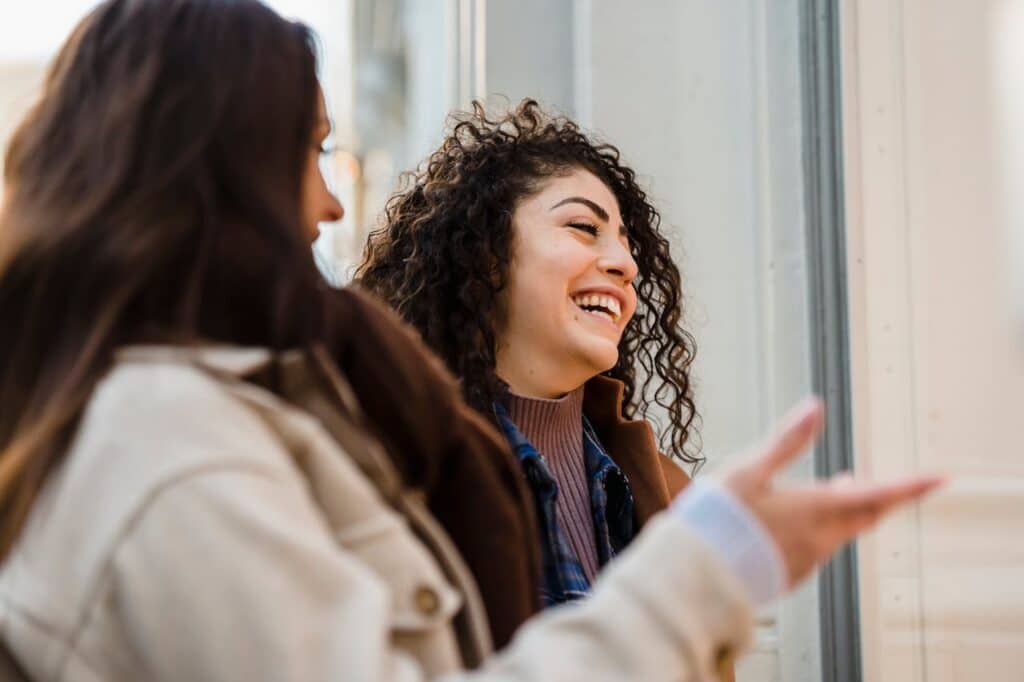 Two women having an open and supportive conversation outdoors representing emotional connection and personal growth