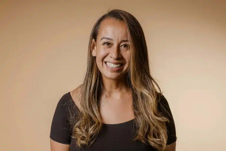 A woman with long hair smiling