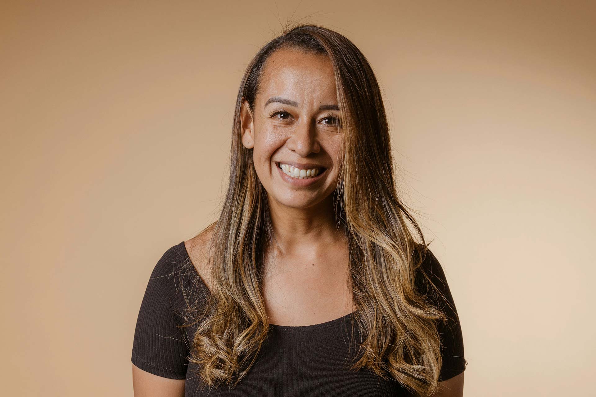 A woman with long hair smiling
