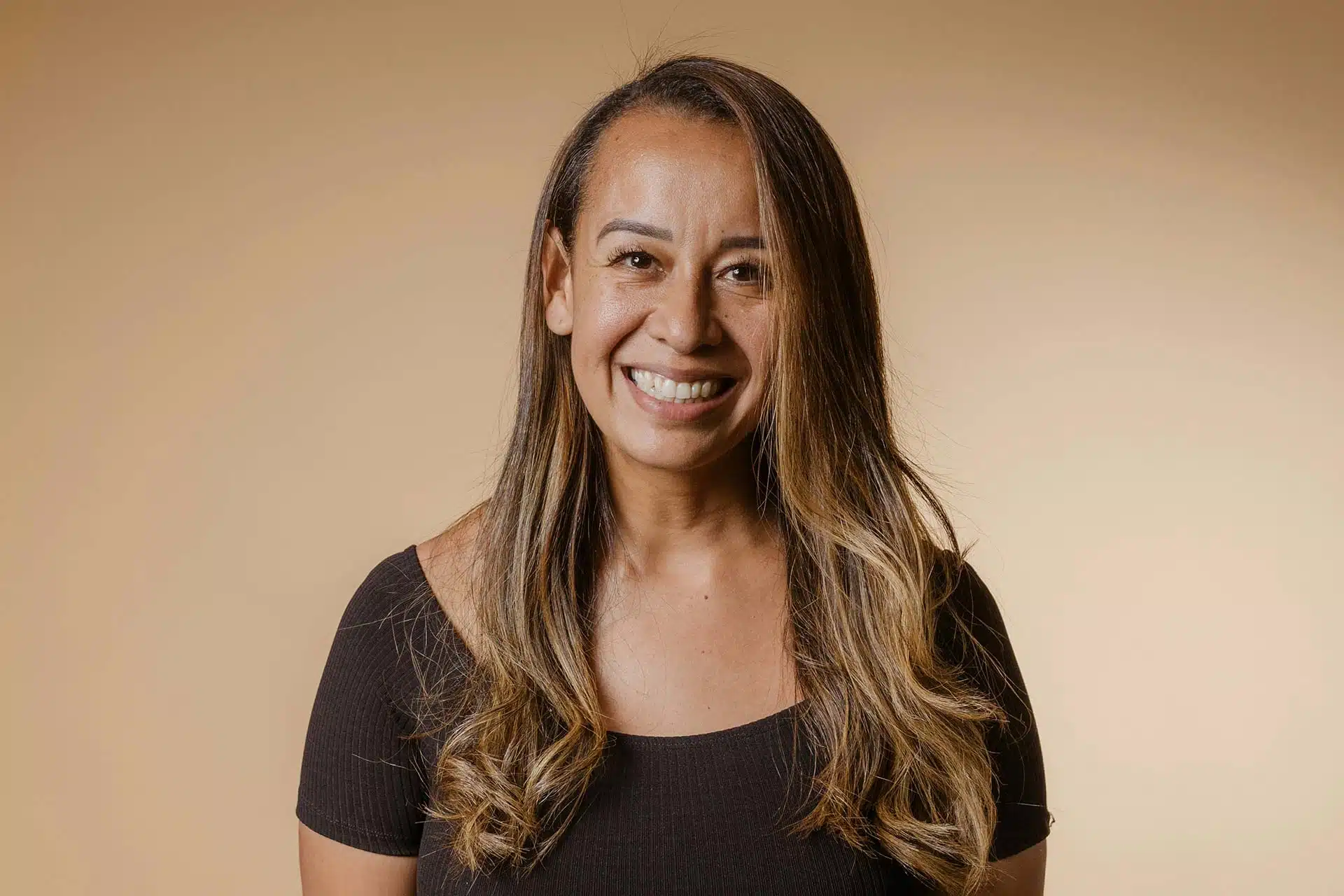 A woman with long hair smiling